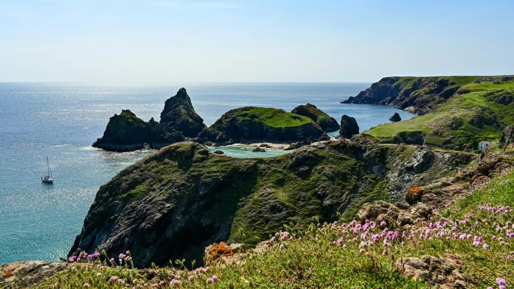 Explore the breathtaking scenery of Kynance Cove on a sunny summer day in Cornwall, UK.